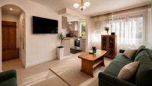 a living room with a couch and a table at Apartament Okrzei in Lublin
