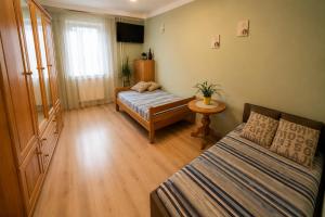 a small room with two beds and a table at Apartament Okrzei in Lublin