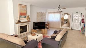 a living room with two couches and a fireplace at Casa Lua Guesthouse in Burgau