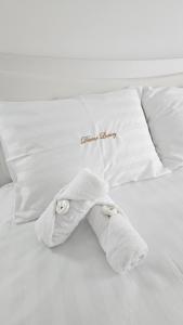 a towel animal laying on a bed with pillows at Divine Luxury Rasnov in Râşnov