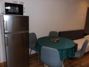a small kitchen with a table and a refrigerator at Oporto apartment Batalha in Porto +22 photos