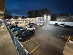 a parking lot with cars parked in front of a building at Riviera motel in Detroit