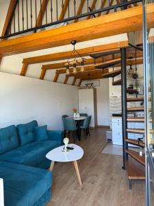 a living room with a blue couch and a table at Bungalows Panorama Hills in Plužine
