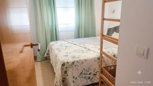a small bedroom with a bed and a ladder at ILDA MENTa in Miami Platja