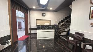 a room with a staircase with a counter and chairs at Shreeji Nikunjdham in Vrindāvan