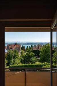 a window view of the water from a house at Seeblick Apartment Meersburg in Meersburg