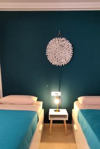 a bedroom with two beds and a lamp on a table at Casa Girasoles terraza patio aire acondicionado in Corralejo +28 photos