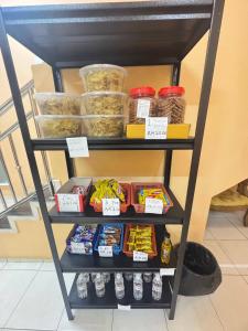 a shelf with different food items on it at Hotel RS Inn in Rantau Panjang