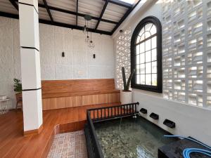 a large room with a pool in the middle of it at Emmir Homestay in Cilacap +2 photos
