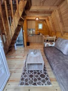 a living room with a couch and a table at Gnijezdo ispod greda in Šavnik