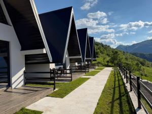 a building with a black roof with a view at Bungalows Panorama Hills in Plužine