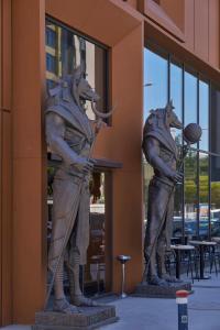 two statues of dogs standing in front of a building at Ramses Hotel İzmir in İzmir