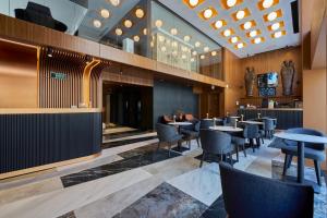 a restaurant with tables and chairs and a bar at Ramses Hotel İzmir in İzmir