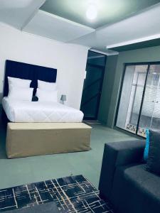 a bedroom with a bed and a couch in it at R&N Hosts Mokhotlong in Mokoeng +13 photos
