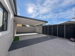 an empty balcony of a house with a fence at Pecan Tree Lodge in Cape Town +2 photos