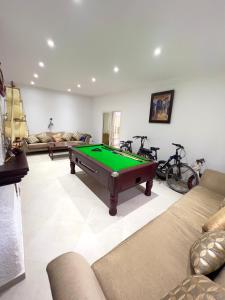 a living room with a pool table in it at Villa Yassir expert Cabo in Cabo Negro