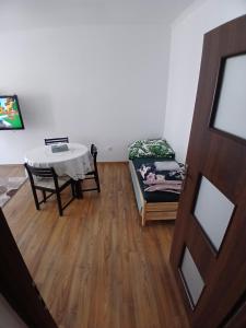 a living room with a table and a couch at Friendly House in Bolesławiec