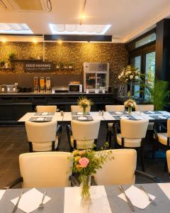 a restaurant with tables and chairs and a counter at Hotel Taormina Brussels Airport in Zaventem