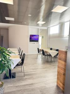 an office with tables and chairs and a projection screen at Hotel Angi in Fossò