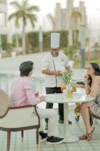 a man in a chefs hat standing next to a table at White Wharf Manesar in Gurgaon +39 photos
