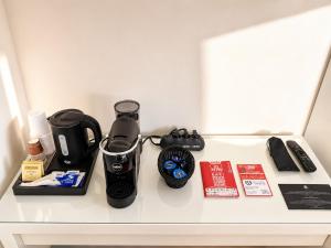 a counter top with a coffee maker and a watch at Del Console Apartment 2 - Near Bari Airport & Station in Modugno