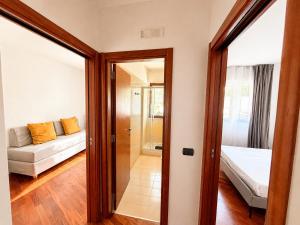 a living room with a couch and a mirror at Del Console Apartment 2 - Near Bari Airport & Station in Modugno