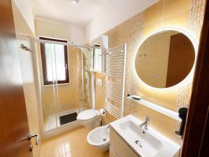a bathroom with a sink and a toilet and a mirror at Del Console Apartment 2 - Near Bari Airport & Station in Modugno +17 photos