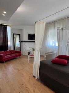 a bedroom with a bed and a living room at Hotel Angi in Fossò