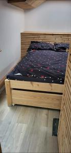 a bed with a wooden frame in a bedroom at Ranč na hribu in Trebnje