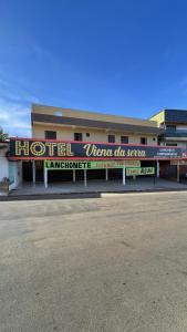 a building with a sign that reads women in service at hotel viena da serra in Luziânia