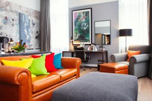 a living room with a couch with colorful pillows at Malmaison Edinburgh in Edinburgh +63 photos