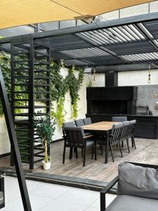 a patio with a table and chairs and a piano at Madrid Luxury Villa in Al Rama