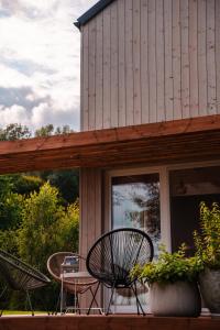 a patio with chairs and a table on a house at PrzyStań w Ciszy in Kozielec
