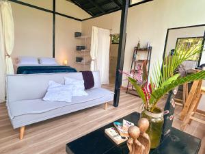 a living room with a couch and a bed at Minca Ecohabs Hotel in Minca