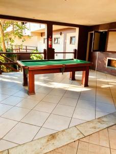 a pool table sitting on top of a patio at Beachfront suite right on the sand in Cabo Frio