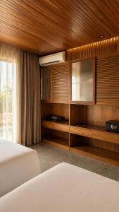 a hotel room with a bed and a television at Vanara Resort and Spa in Uluwatu +115 photos
