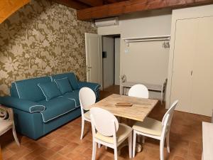 a living room with a couch and a table and chairs at La Quiete di Rivalta in Rivalta Trebbia