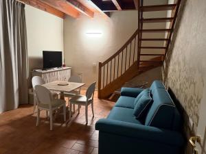a living room with a blue couch and a table at La Quiete di Rivalta in Rivalta Trebbia