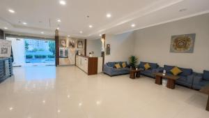 a large living room with blue couches and tables at براديس لاند نبراس الهدئ in Mecca