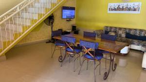 a table and chairs in a room with a staircase at Villa Reine Saly in Saly Portudal
