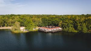 a large house on an island in the middle of a lake at Boshuisje Rekem - Nirvana in Lanaken