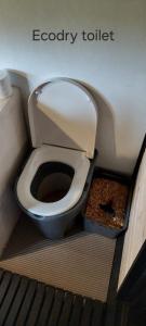 a bathroom with a toilet in a room at Little Red Sauna by the Sea in Leesi