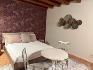 a bedroom with a bed and a small table at La Quiete di Rivalta in Rivalta Trebbia
