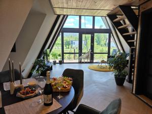a living room with a table with food and wine bottles at Api Chalet in Avrig +94 photos
