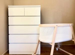 a white dresser next to a white chest of drawers at BorgoLuce Spacious Apt - FREE Parking - Near Airport & Center in Bergamo