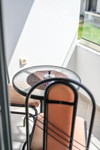 a table and chairs in a room with a window at Apartman Amin&Amina in Ulcinj +36 photos