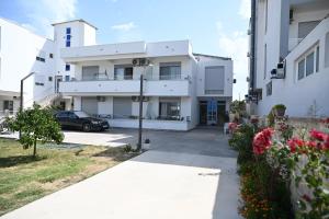 a building with a car parked in front of it at Apartman Amin&Amina in Ulcinj