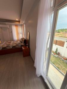 a bedroom with a bed and a large window at Zensole Resort in Tarlac +55 photos