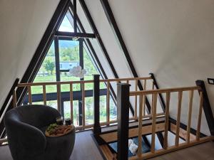 a room with a chair and a large window at Api Chalet in Avrig