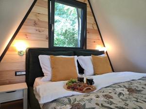 a bedroom with a bed with a tray of food on it at Api Chalet in Avrig